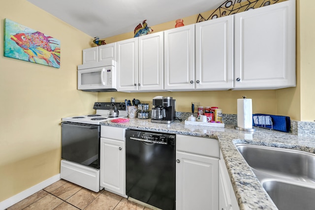 kitchen featuring light tile patterned floors, white appliances, white cabinetry, and sink