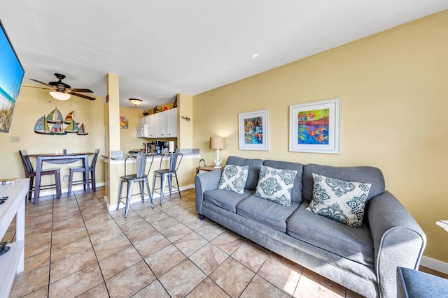 tiled living room featuring ceiling fan