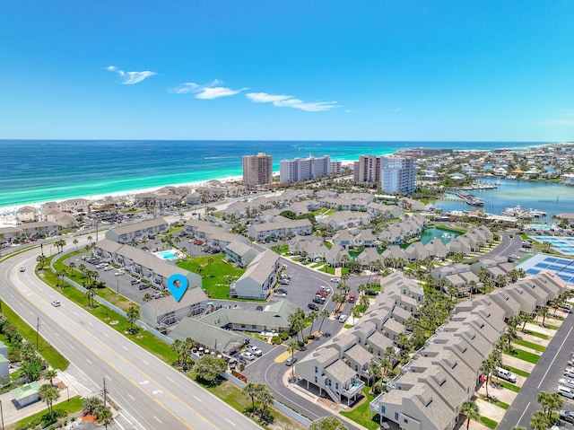 birds eye view of property with a water view and a beach view