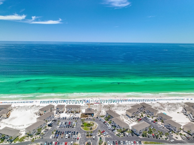 drone / aerial view featuring a beach view and a water view