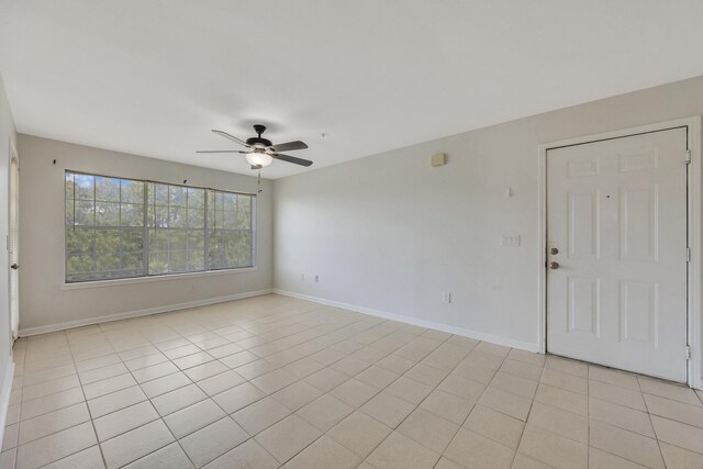 spare room featuring ceiling fan and light tile patterned floors