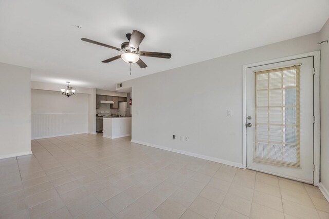 unfurnished living room featuring ceiling fan with notable chandelier and light tile patterned floors