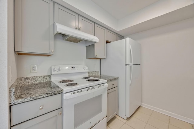 kitchen with gray cabinetry, white appliances, light stone countertops, and light tile patterned floors