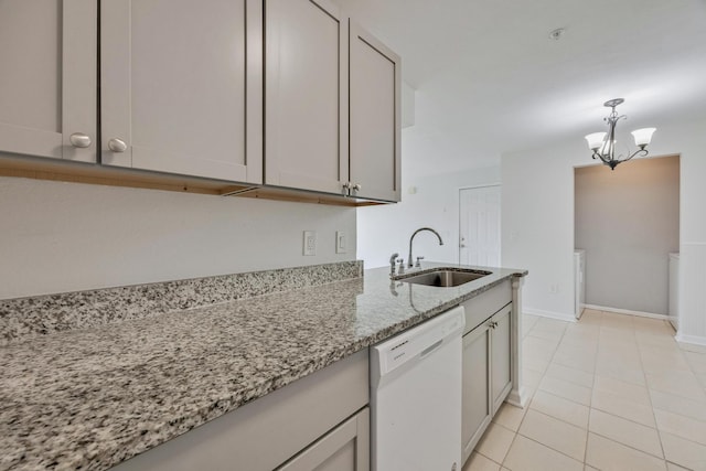 kitchen featuring light stone counters, light tile patterned floors, sink, a chandelier, and dishwasher