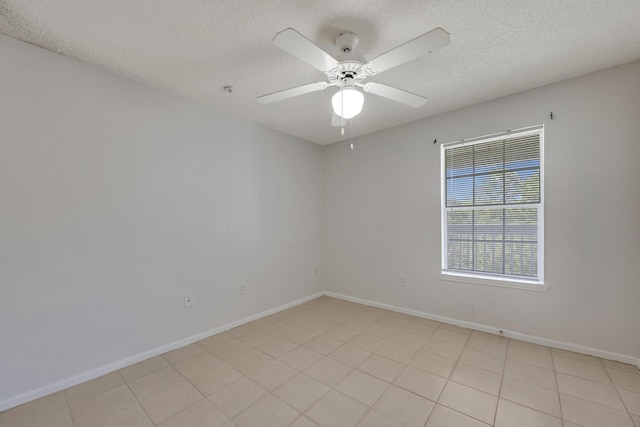 tiled empty room with a textured ceiling and ceiling fan