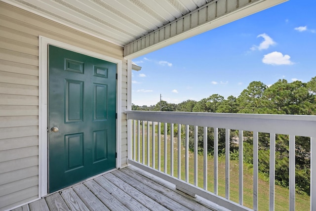 view of exterior entry with a balcony