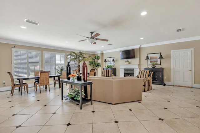 tiled living room featuring ceiling fan and crown molding