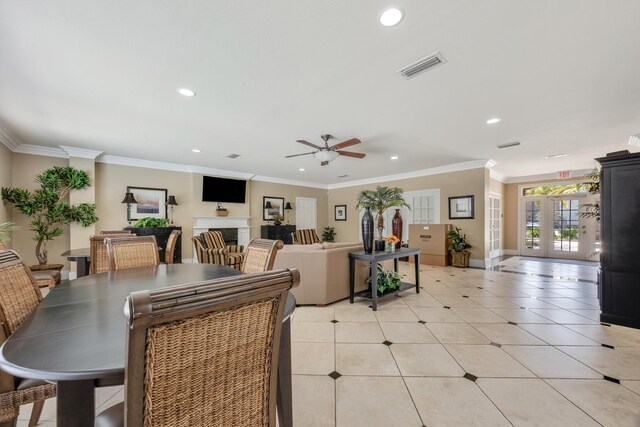 tiled dining area with crown molding, ceiling fan, and french doors