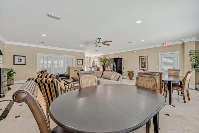 dining room featuring crown molding, light tile patterned flooring, and ceiling fan