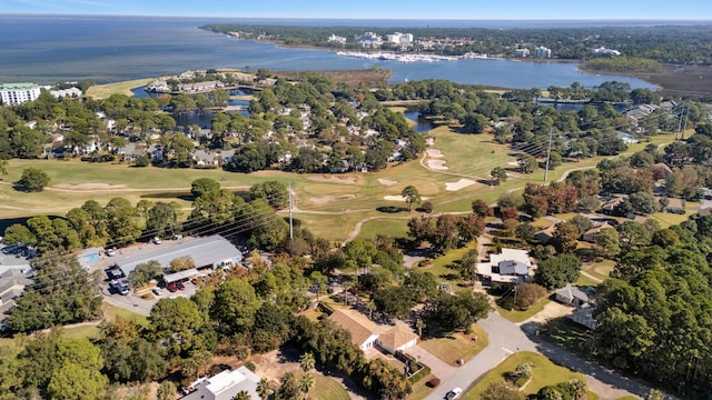 drone / aerial view with view of golf course and a water view
