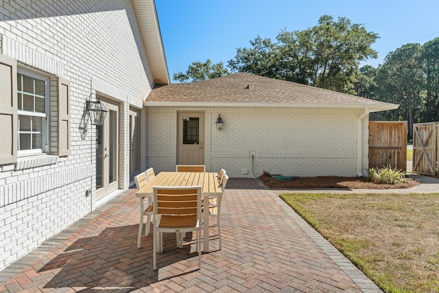 view of patio with outdoor dining space and fence