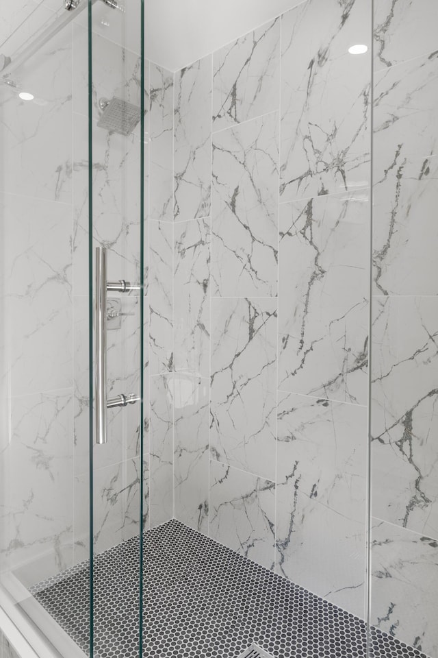 full bath with a marble finish shower