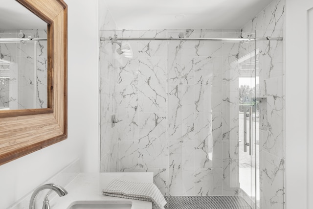 bathroom with sink and a shower with shower door