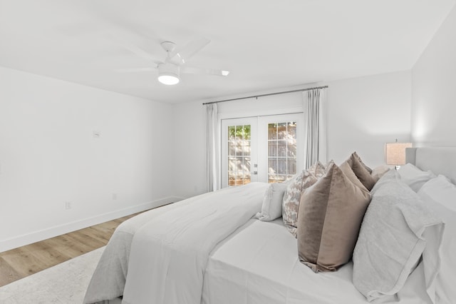 bedroom featuring french doors, hardwood / wood-style flooring, access to exterior, and ceiling fan