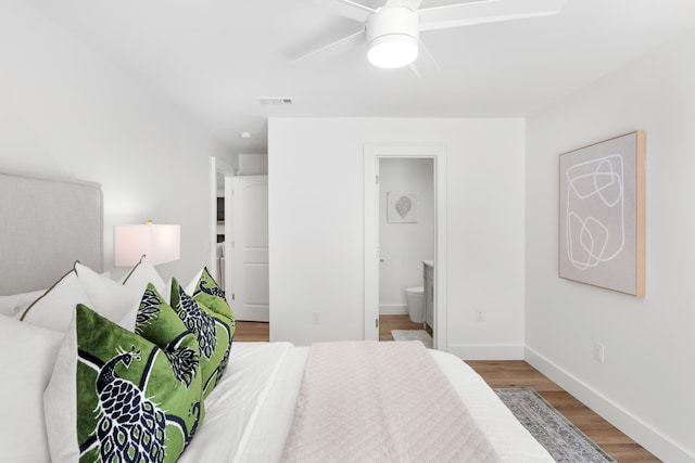 bedroom with hardwood / wood-style floors, connected bathroom, and ceiling fan