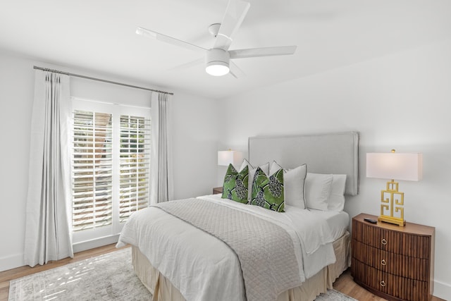 bedroom with light hardwood / wood-style floors and ceiling fan