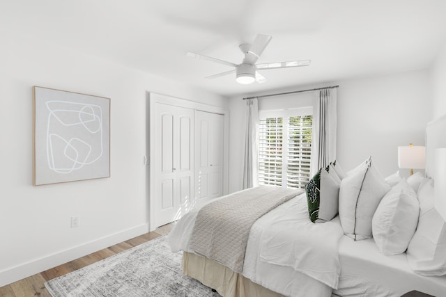 bedroom featuring light hardwood / wood-style flooring, a closet, and ceiling fan