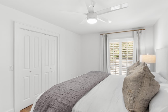 bedroom with wood finished floors, a closet, and ceiling fan