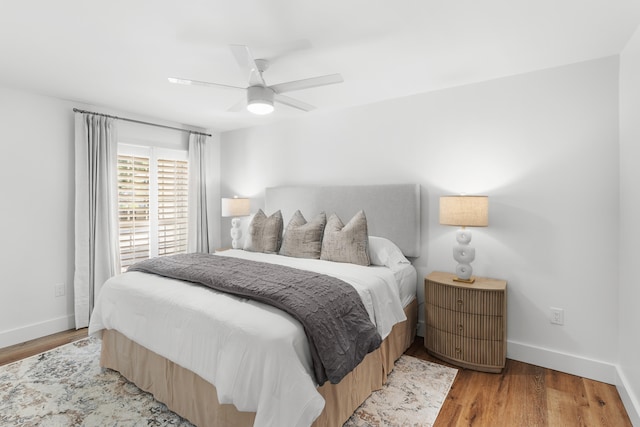 bedroom with light hardwood / wood-style floors and ceiling fan