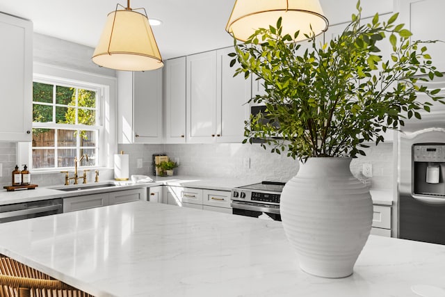 kitchen featuring light stone counters, stainless steel appliances, and decorative backsplash