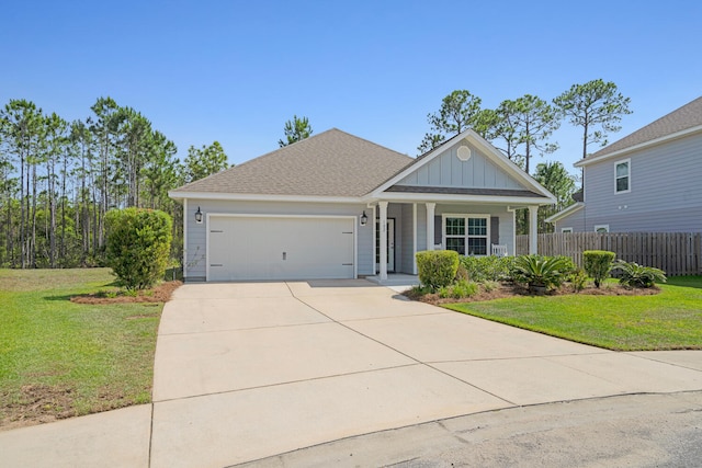 view of front facade featuring a porch, a garage, and a front yard