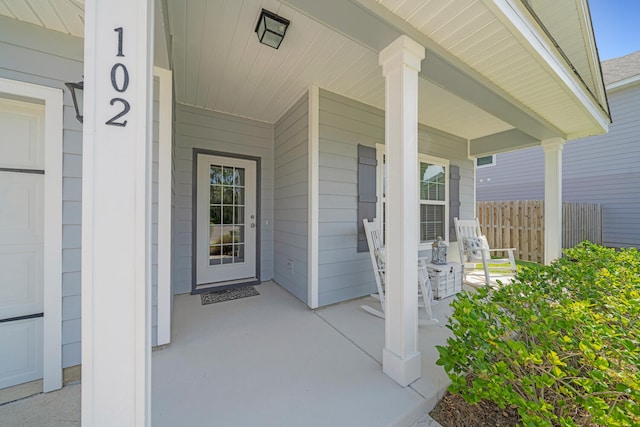 view of exterior entry with covered porch