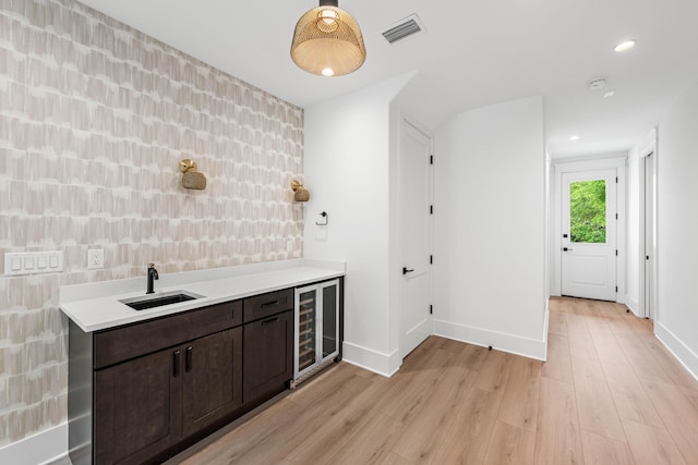 394 Grande Pointe Cir, Inlet Beach, FL 32461 - bar area with wine cooler, a sink, light wood finished floors, baseboards, and recessed lighting