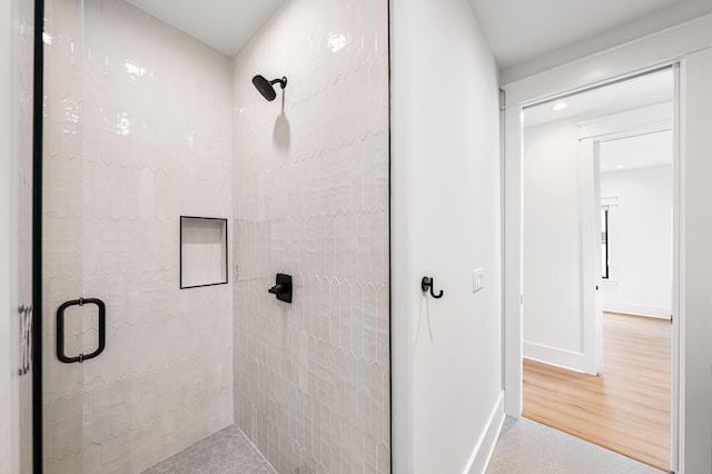 394 Grande Pointe Cir, Inlet Beach, FL 32461 - full bathroom with a stall shower, baseboards, and wood finished floors
