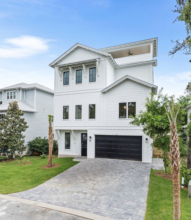 394 Grande Pointe Cir, Inlet Beach, FL 32461 - view of front facade with a garage, a front yard, decorative driveway, and board and batten siding