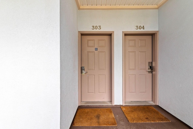 property entrance with stucco siding
