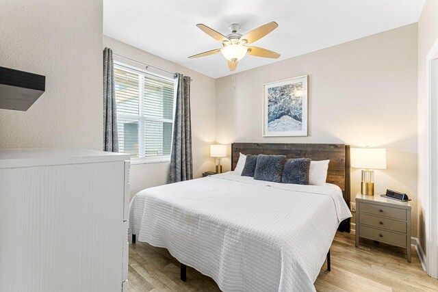 bedroom with ceiling fan and light wood-type flooring