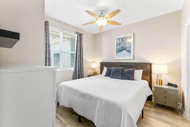 bedroom with a ceiling fan and light wood-style floors