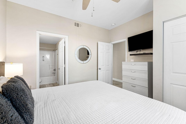 bedroom featuring connected bathroom, baseboards, visible vents, and ceiling fan
