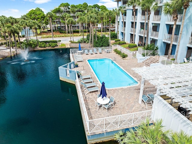 view of swimming pool featuring a water view