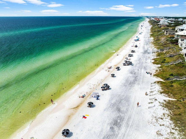 drone / aerial view featuring a view of the beach and a water view