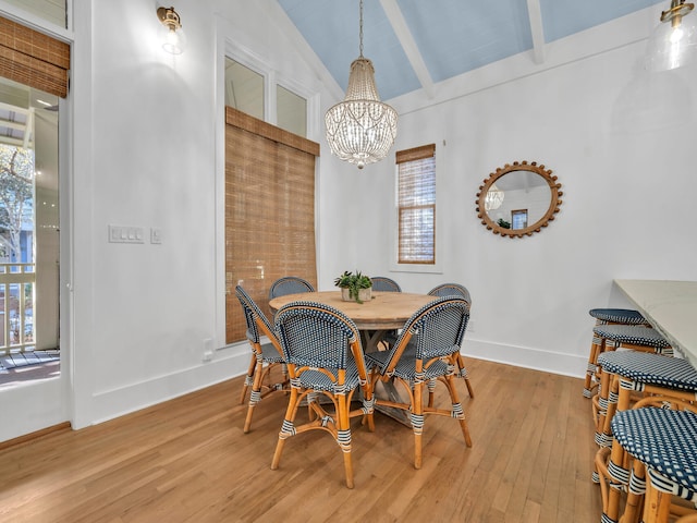 147 Silver Laurel Way, Santa Rosa Beach, FL 32459 - dining area with a chandelier, plenty of natural light, vaulted ceiling with beams, and light wood finished floors