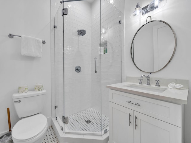 bathroom featuring toilet, tile patterned flooring, vanity, and a shower with door