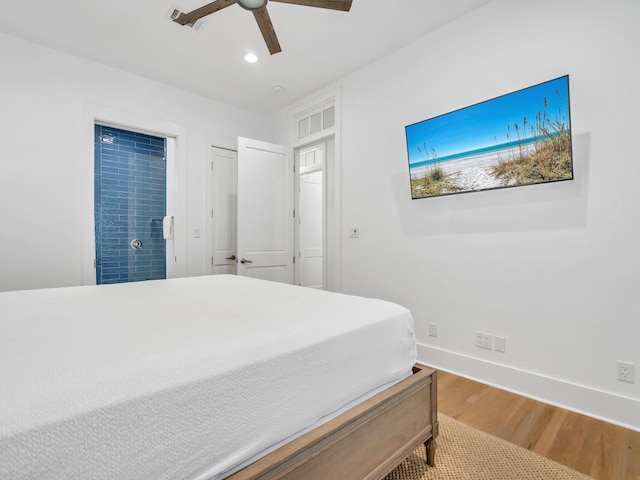 bedroom with hardwood / wood-style flooring and ceiling fan