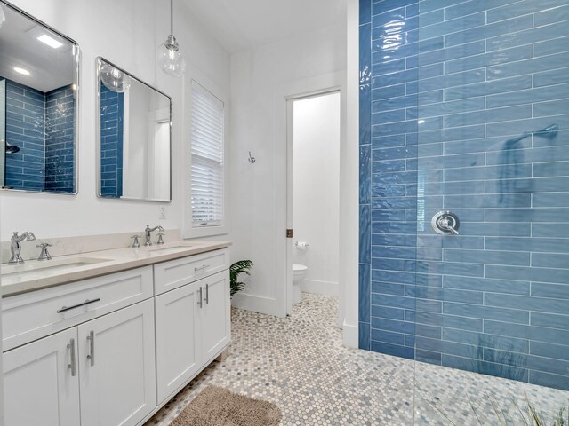 147 Silver Laurel Way, Santa Rosa Beach, FL 32459 - bathroom with a sink, a tile shower, toilet, and double vanity