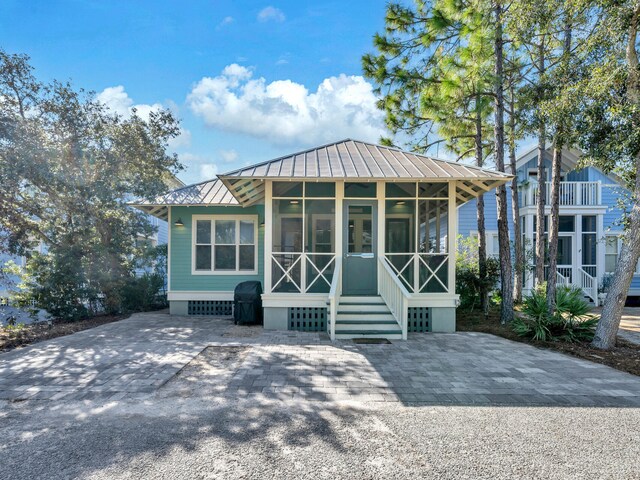 147 Silver Laurel Way, Santa Rosa Beach, FL 32459 - view of front facade featuring a sunroom, metal roof, and a standing seam roof