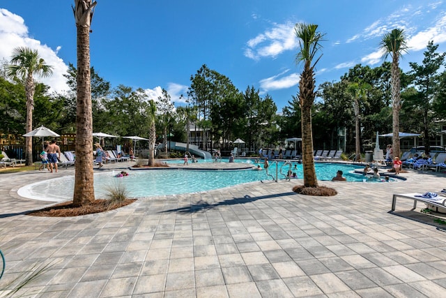 view of pool with a patio area and a water slide