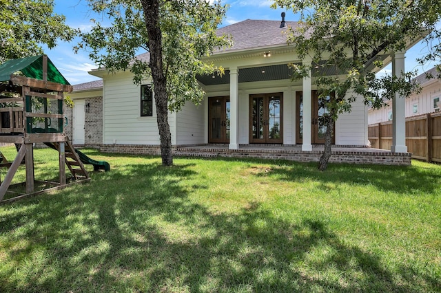 view of front of house with a playground and a front yard