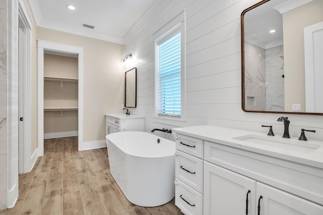 bathroom with vanity, ornamental molding, wooden walls, plus walk in shower, and hardwood / wood-style floors