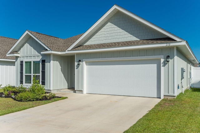 view of front of house with a front yard and a garage