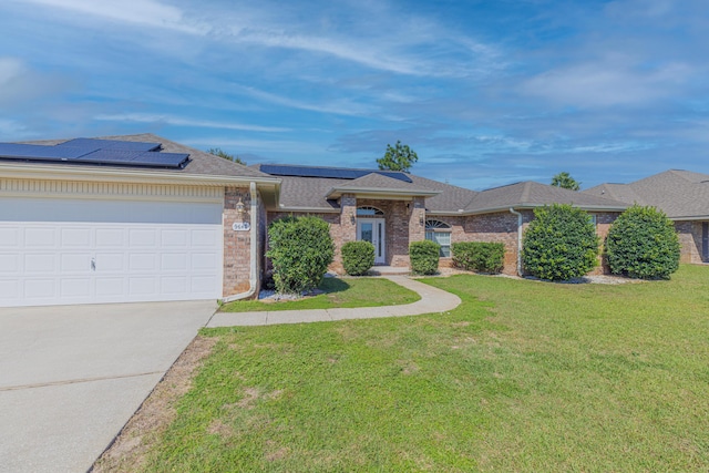 single story home featuring a front yard, a garage, and solar panels