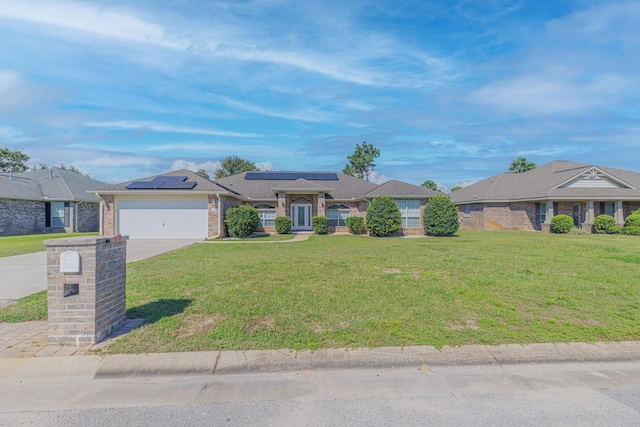 single story home with a front lawn, solar panels, and a garage