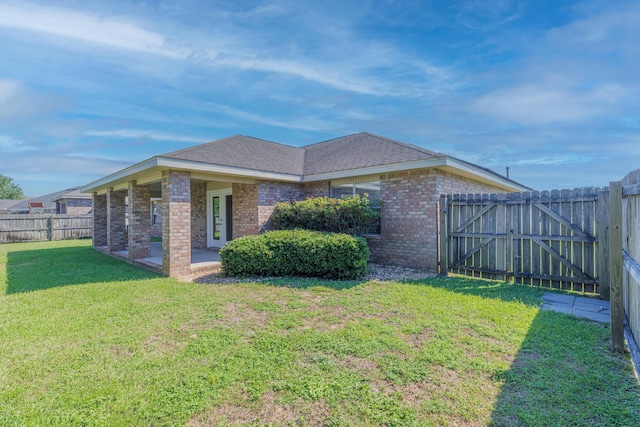 view of side of home with a lawn