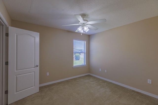 unfurnished room featuring light carpet, a textured ceiling, and ceiling fan