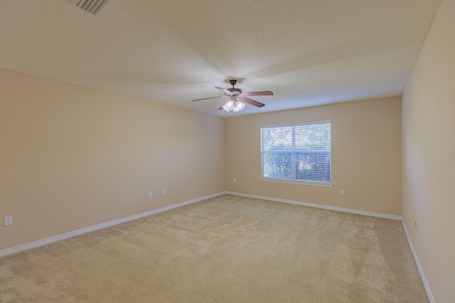 unfurnished room with light carpet, a textured ceiling, and ceiling fan