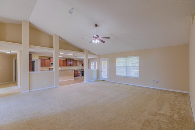 unfurnished living room featuring ceiling fan, light colored carpet, and high vaulted ceiling